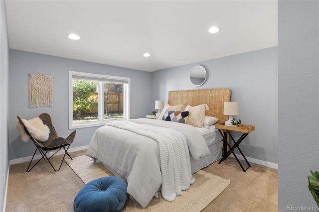 a bedroom with a bed and chair