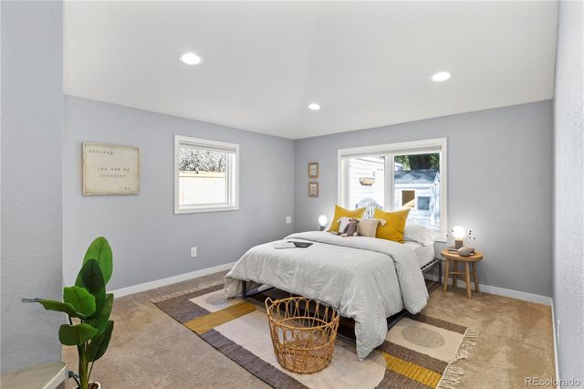 a bedroom with bed and a window