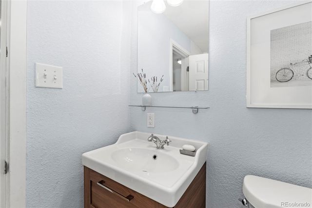 a bathroom with a sink a toilet and mirror