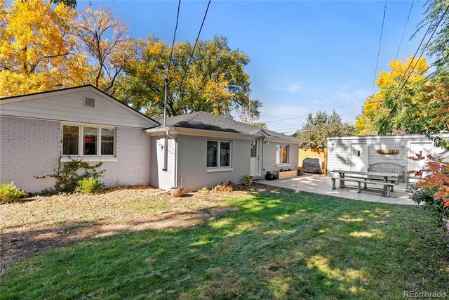 a front view of a house with a garden and yard