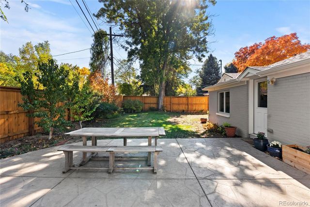 a view of a patio with table and chairs and potted plants