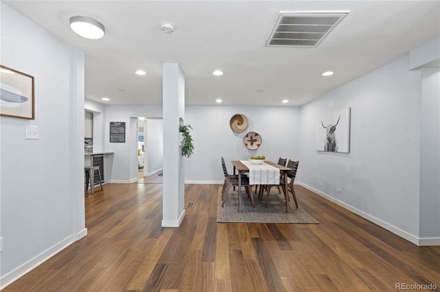 a view of a dining room with furniture and wooden floor