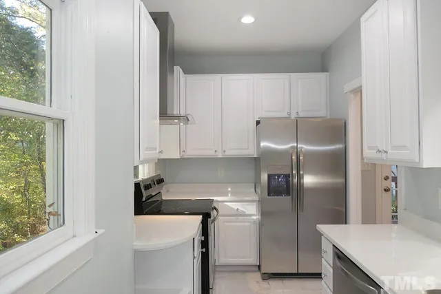 a kitchen with a refrigerator a sink and a stove