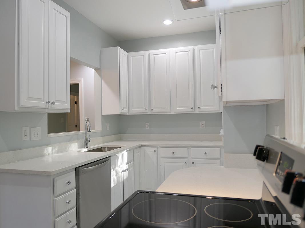304 Columbia Place East Chapel Hill, NC 27516 - Photo 12 of 34 a kitchen with a sink cabinets and appliances