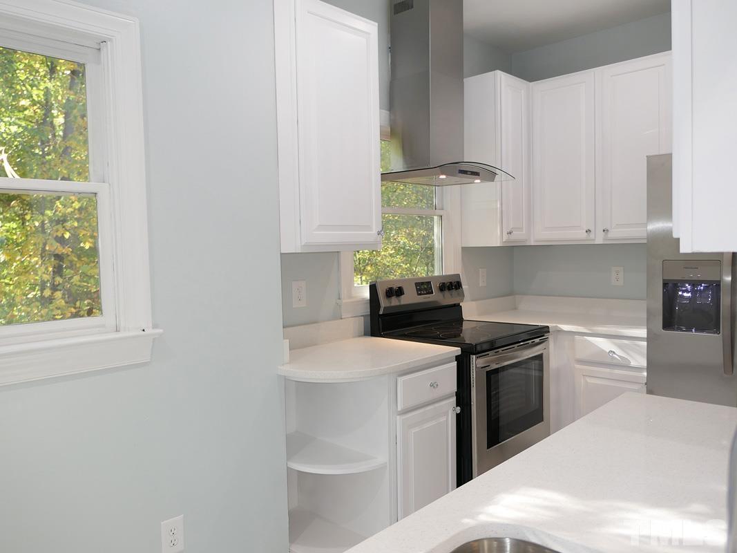 304 Columbia Place East Chapel Hill, NC 27516 - Photo 13 of 34 a kitchen with a sink and cabinets