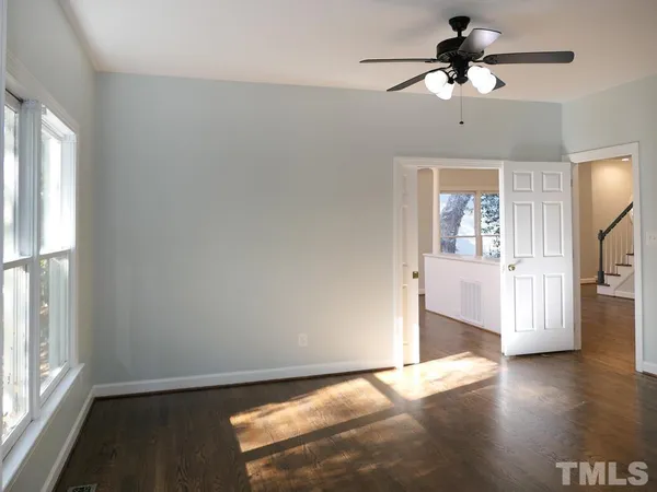 a view of a livingroom with a ceiling fan and window