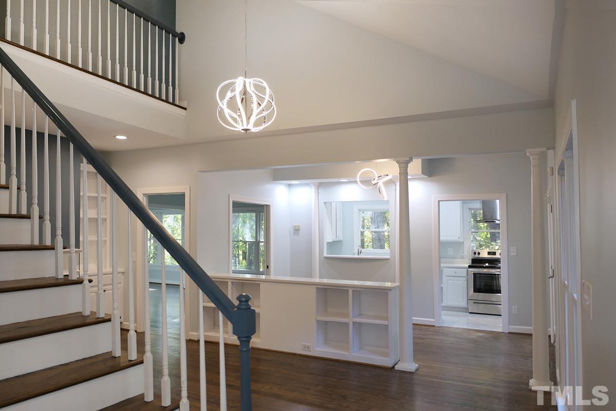 304 Columbia Place East Chapel Hill, NC 27516 - Photo 2 of 34 a view of a hallway with wooden floor and staircase