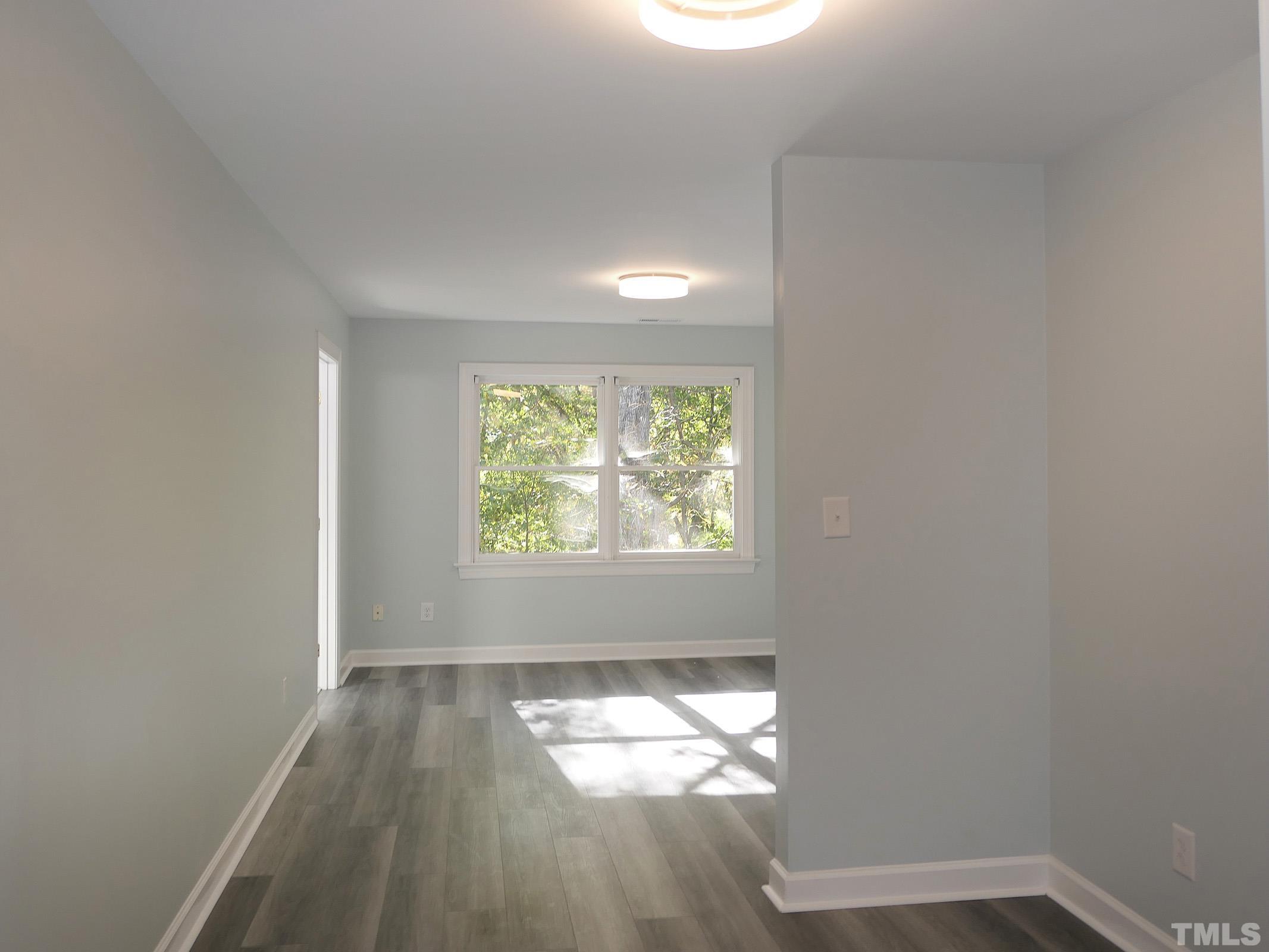304 Columbia Place East Chapel Hill, NC 27516 - Photo 23 of 34 an empty room with wooden floor and windows