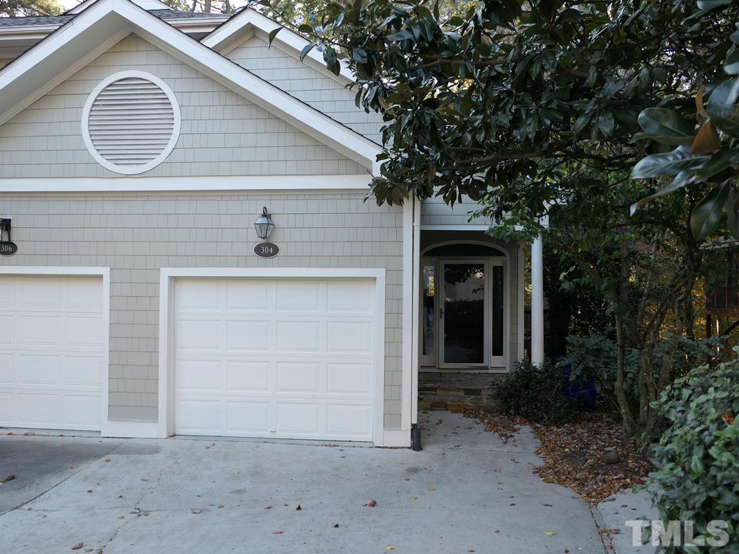 304 Columbia Place East Chapel Hill, NC 27516 - Photo 34 of 34 a front view of a house with a yard and garage