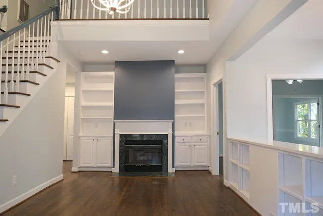 an entryway with hallway and a fireplace