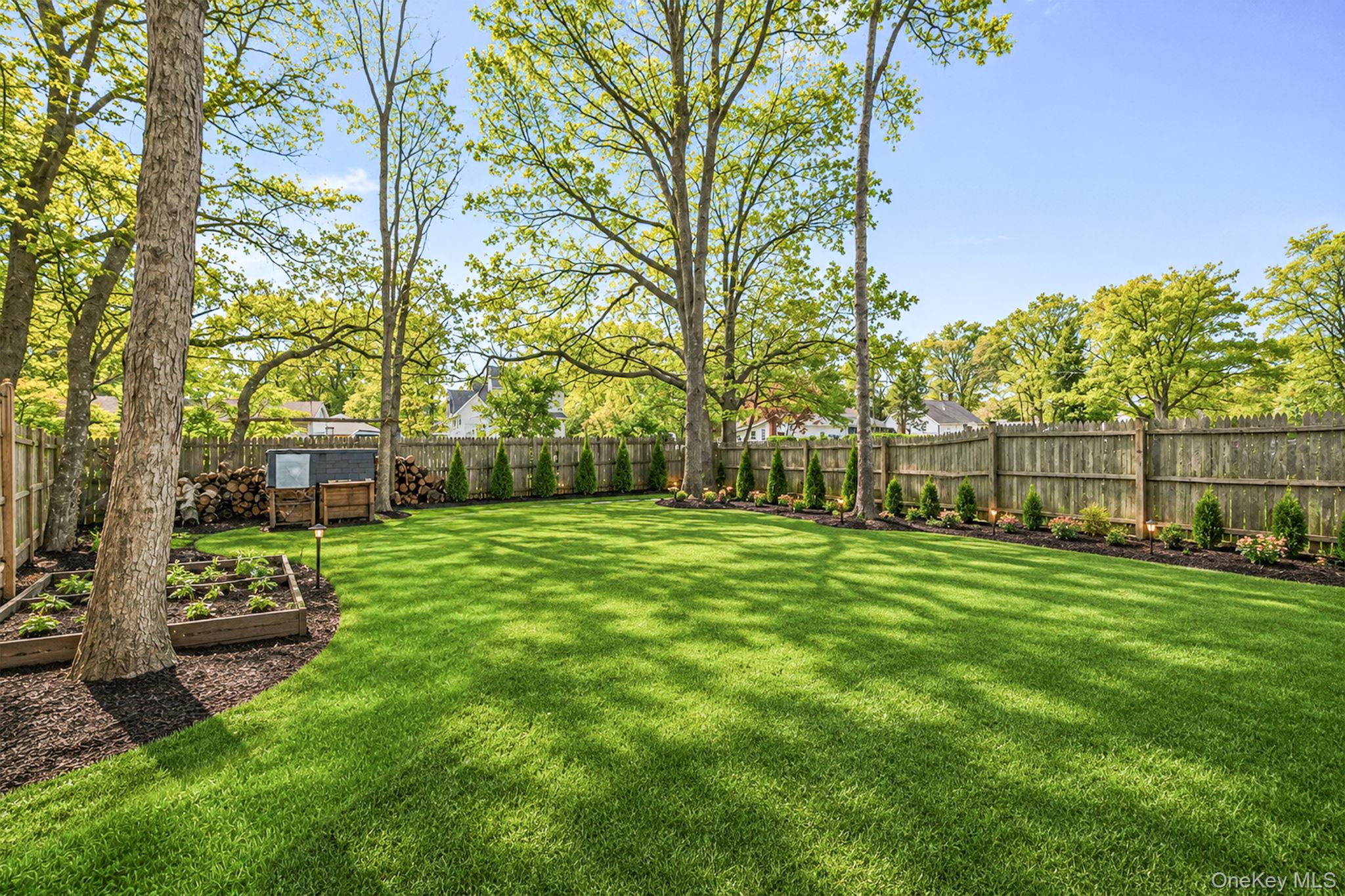332 Commack Road Shirley, NY 11967 - Photo 22 of 25 a view of a backyard with table and chairs and potted plants and large trees