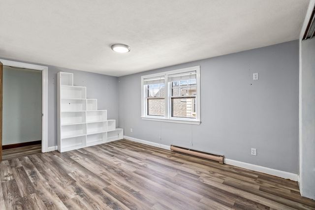 a view of room with wooden floor and window