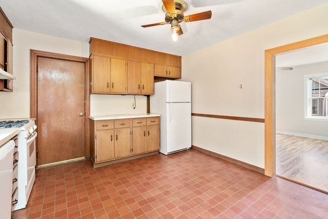 a view of a kitchen with refrigerator and cabinet