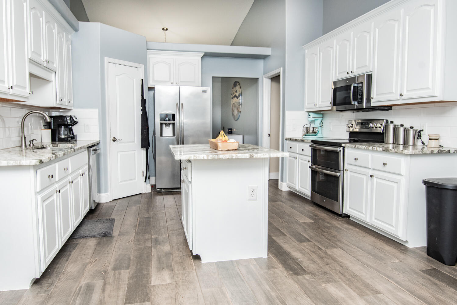 530 Vulpes Sanctuary Loop Crestview, FL 32536 - Photo 12 of 31 a kitchen with stainless steel appliances granite countertop a stove top oven a sink dishwasher and a refrigerator