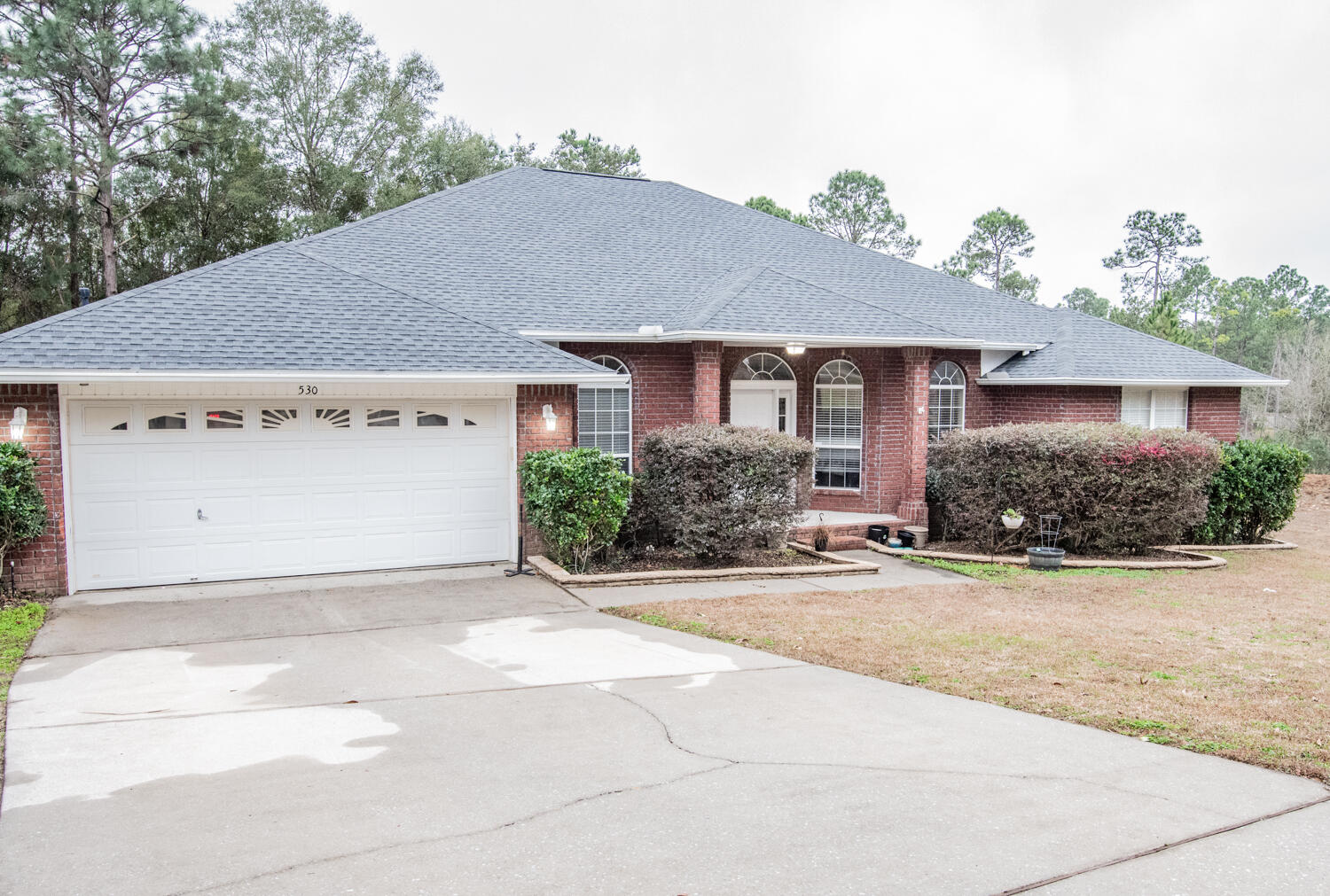 530 Vulpes Sanctuary Loop Crestview, FL 32536 - Photo 2 of 31 front view of a house with a bench