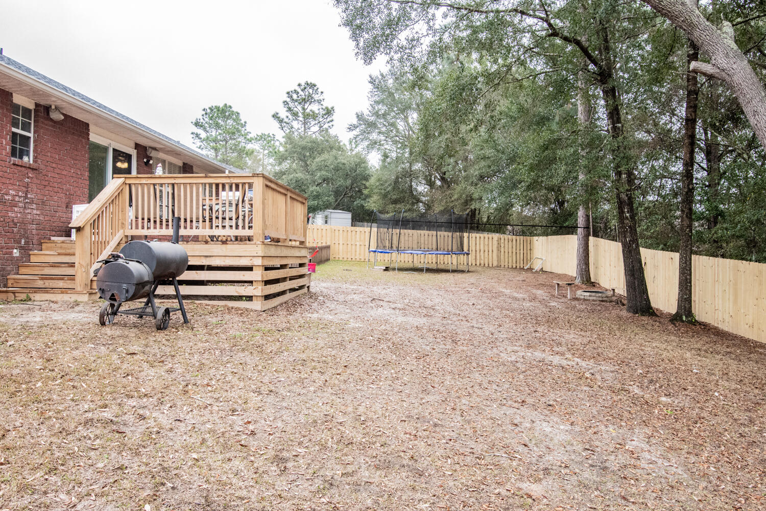 530 Vulpes Sanctuary Loop Crestview, FL 32536 - Photo 30 of 31 a view of a backyard with a large tree