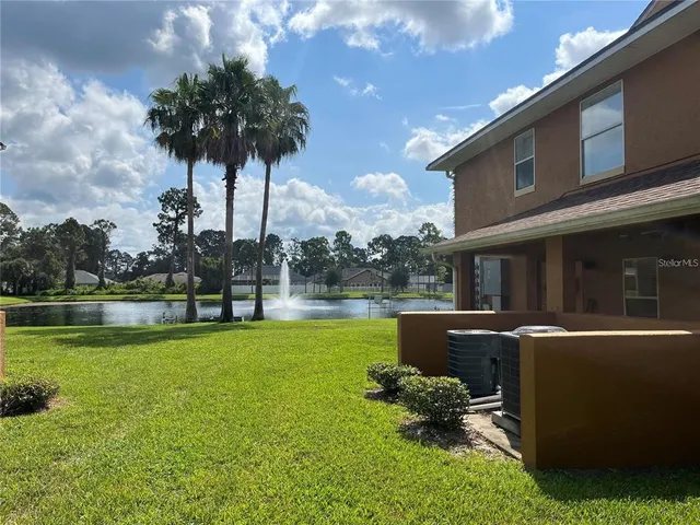 a swimming pool with outdoor seating and garden