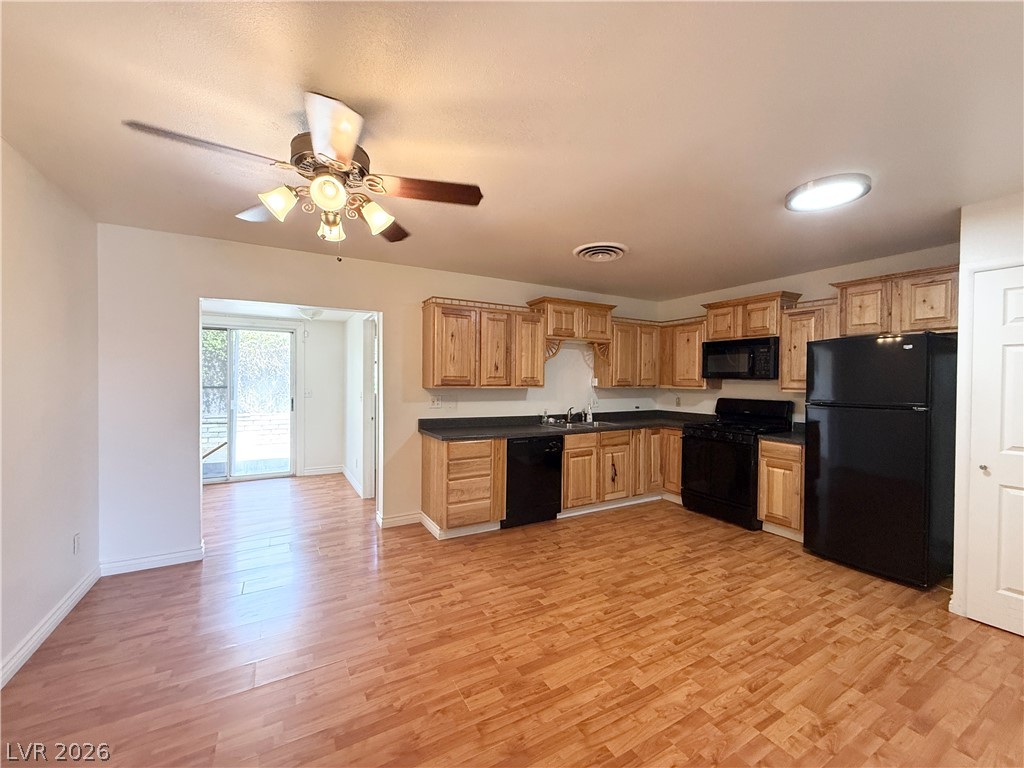 616 Greenway Road Henderson, NV 89002 - Photo 6 of 32 A well-equipped kitchen and dining area provides direct access to an outdoor space, perfect for effortless entertaining.