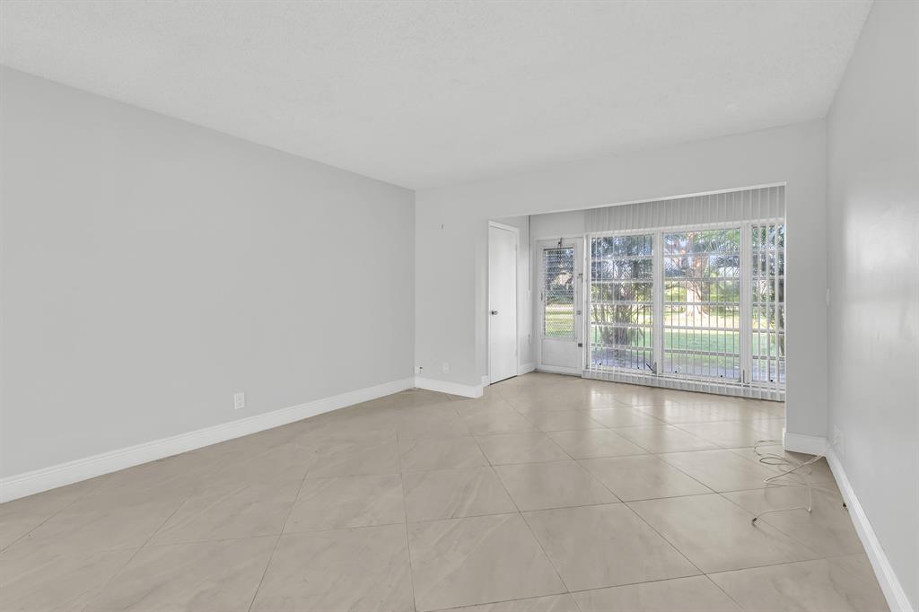 13950 Vía Flora, Unit B Delray Beach, FL 33484 - Photo 11 of 28 a view of an empty room with a window