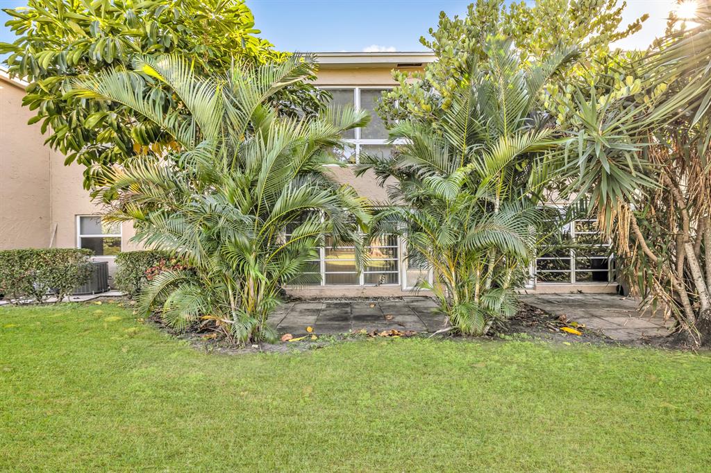 13950 Vía Flora, Unit B Delray Beach, FL 33484 - Photo 26 of 28 front view of house with a yard