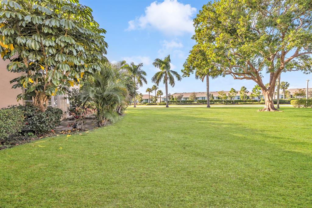 13950 Vía Flora, Unit B Delray Beach, FL 33484 - Photo 27 of 28 a view of yard with trees