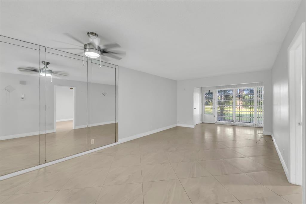 13950 Vía Flora, Unit B Delray Beach, FL 33484 - Photo 7 of 28 wooden floor in an empty room with a window