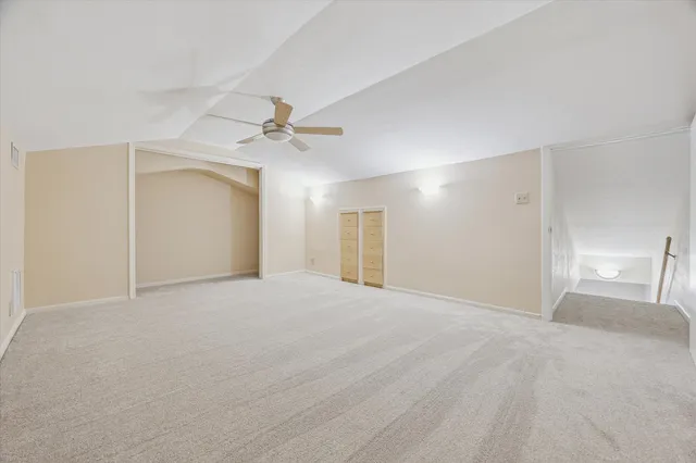 a view of an empty room with a ceiling fan