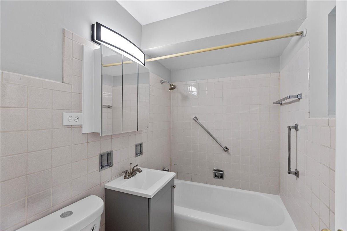 6250 West 64th Place, Unit 103 Chicago, IL 60638 - Photo 24 of 28 a bathroom with a sink a toilet and shower