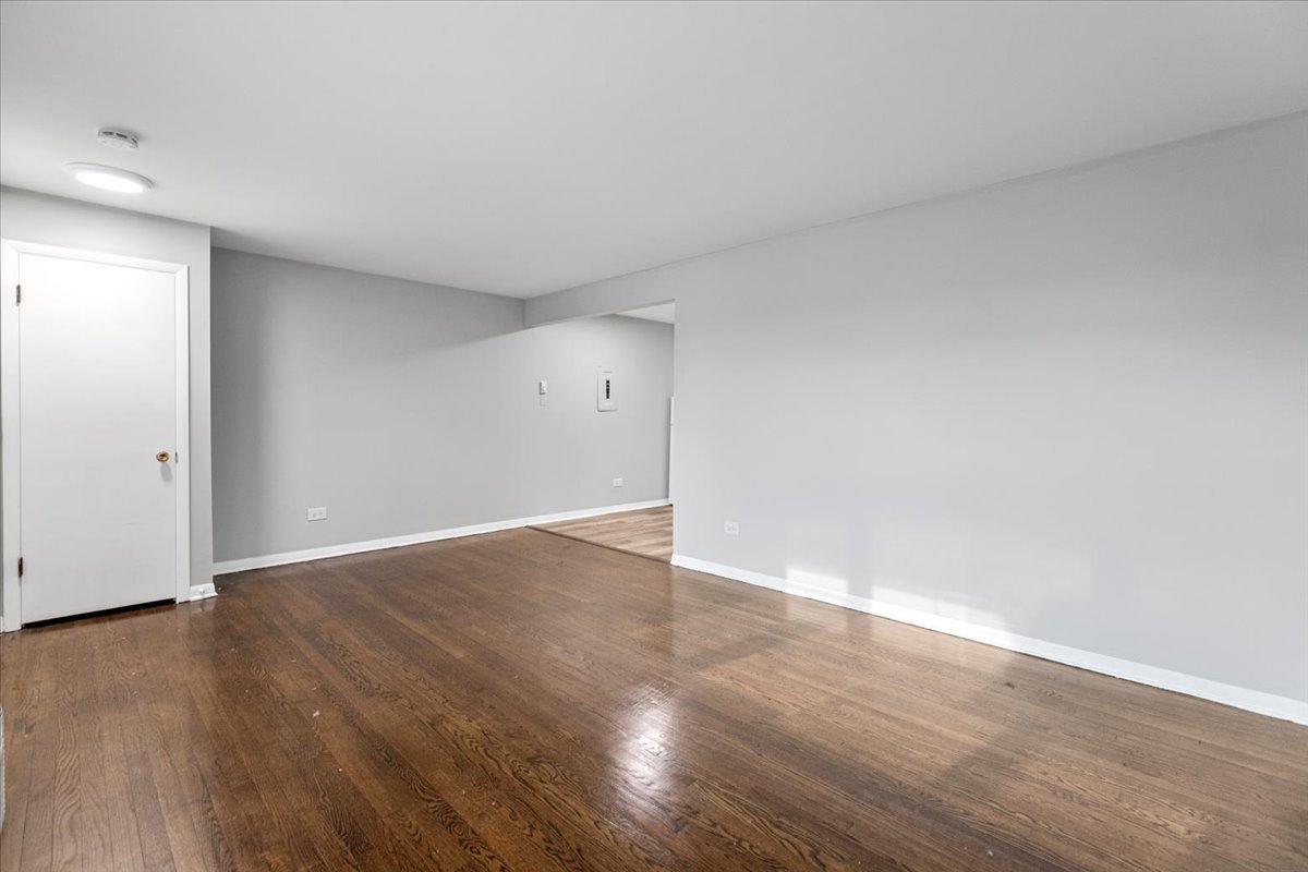 6250 West 64th Place, Unit 103 Chicago, IL 60638 - Photo 10 of 28 a view of an empty room with wooden floor