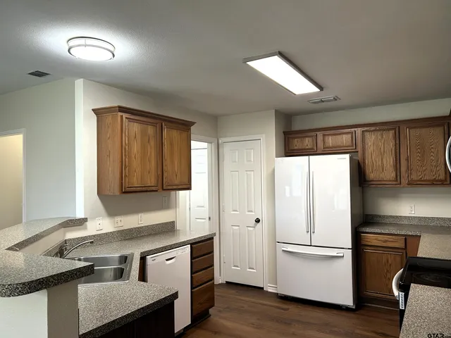 a kitchen with a refrigerator and a sink