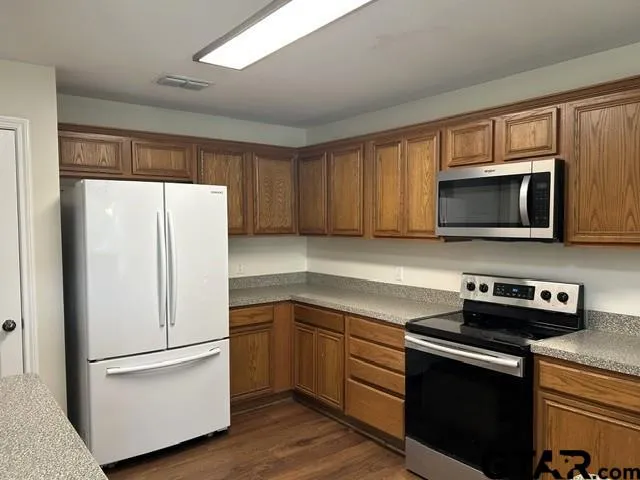 a kitchen with a refrigerator stove and microwave