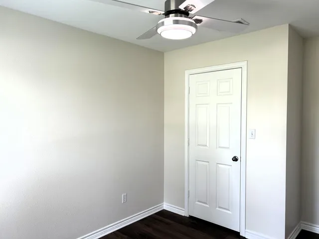a view of a room with wooden floor