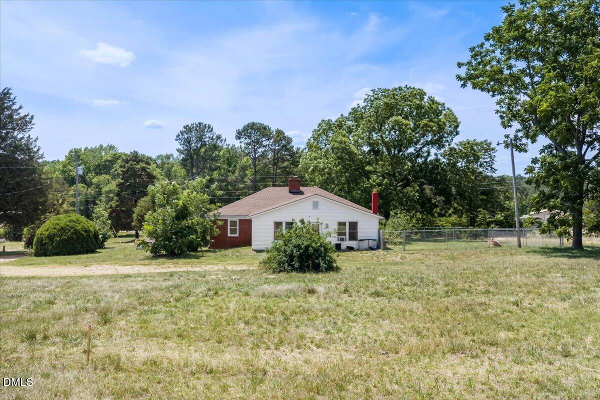 109 Little Ponderosa Road Macon, NC 27551 - Photo 23 of 32 a white house that has a tree in front of it