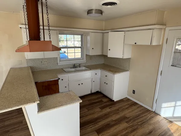 a kitchen with a sink stove and cabinets