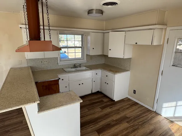 a kitchen with a sink stove and cabinets