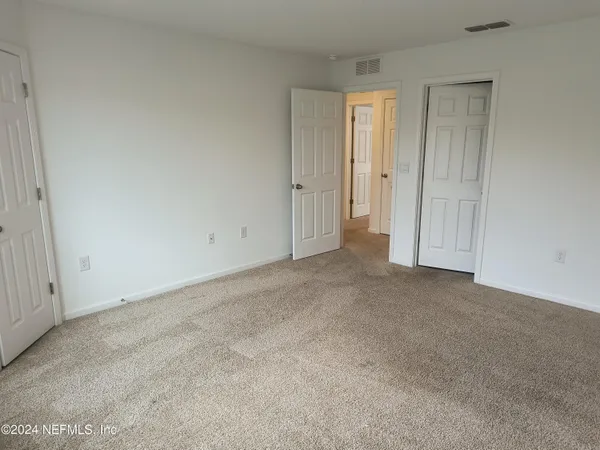 an empty room with closet area