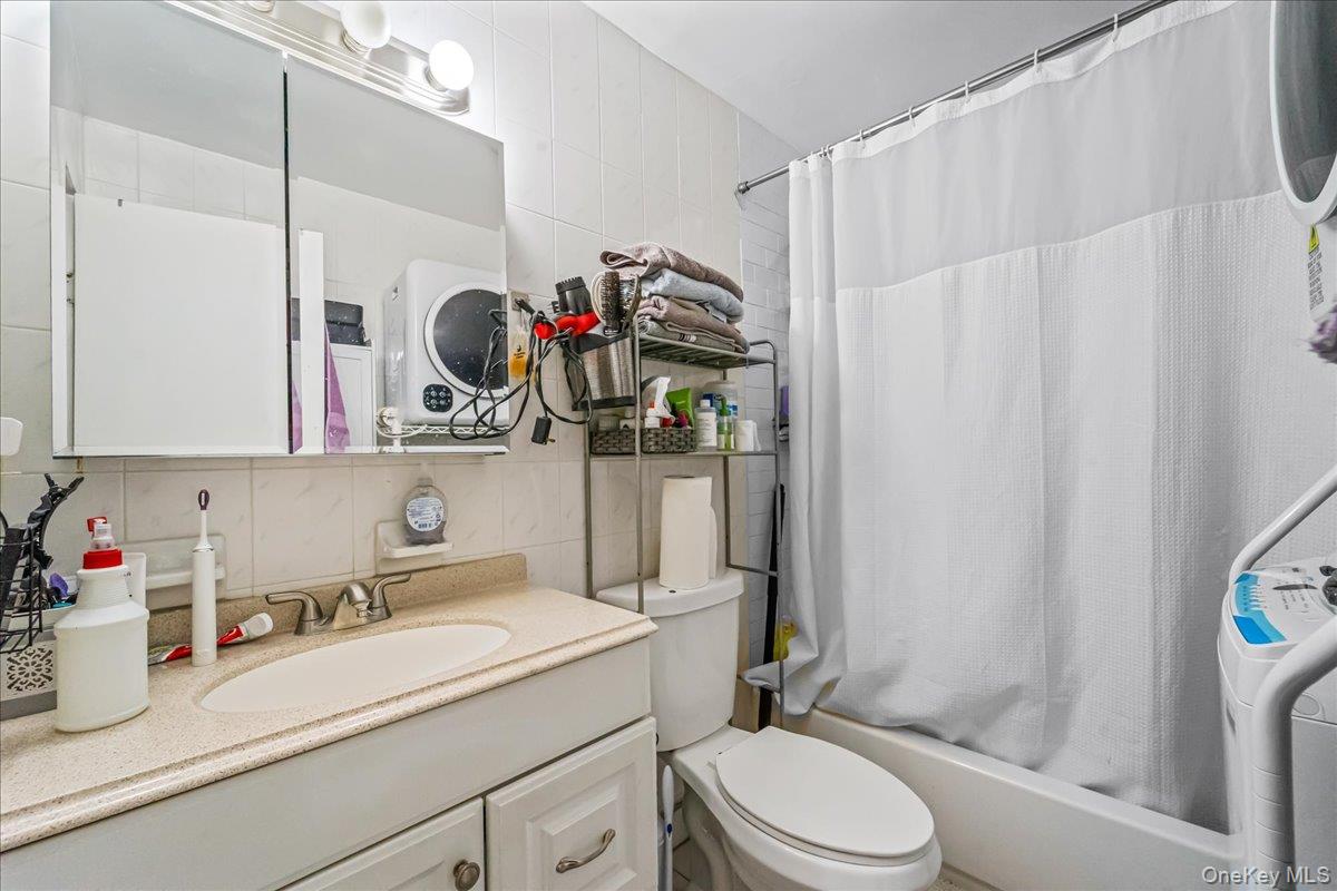 150-02 78th Road Queens, NY 11367 - Photo 12 of 23 a bathroom with a sink vanity mirror and toilet