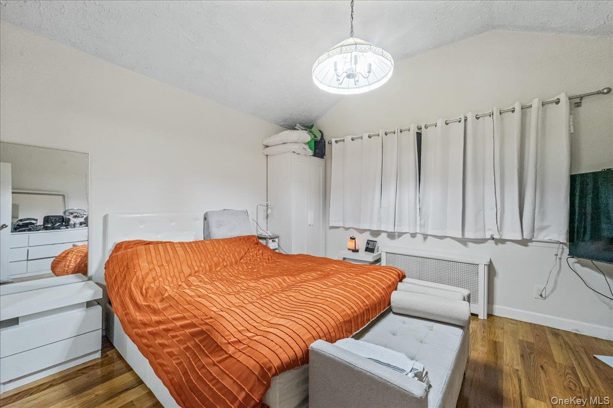 150-02 78th Road Queens, NY 11367 - Photo 13 of 23 a bed sitting in a bedroom and chandelier