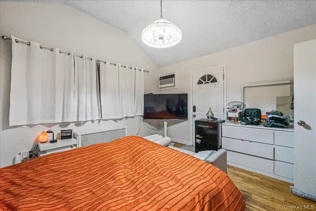 a bedroom with a bed and a television