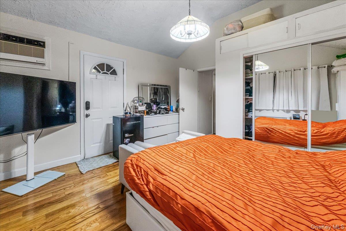 150-02 78th Road Queens, NY 11367 - Photo 15 of 23 a bedroom with a bed and a flat screen tv