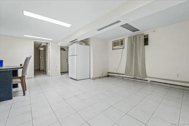 an empty room with furniture and a window