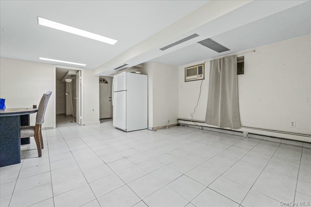 150-02 78th Road Queens, NY 11367 - Photo 16 of 23 an empty room with furniture and a window