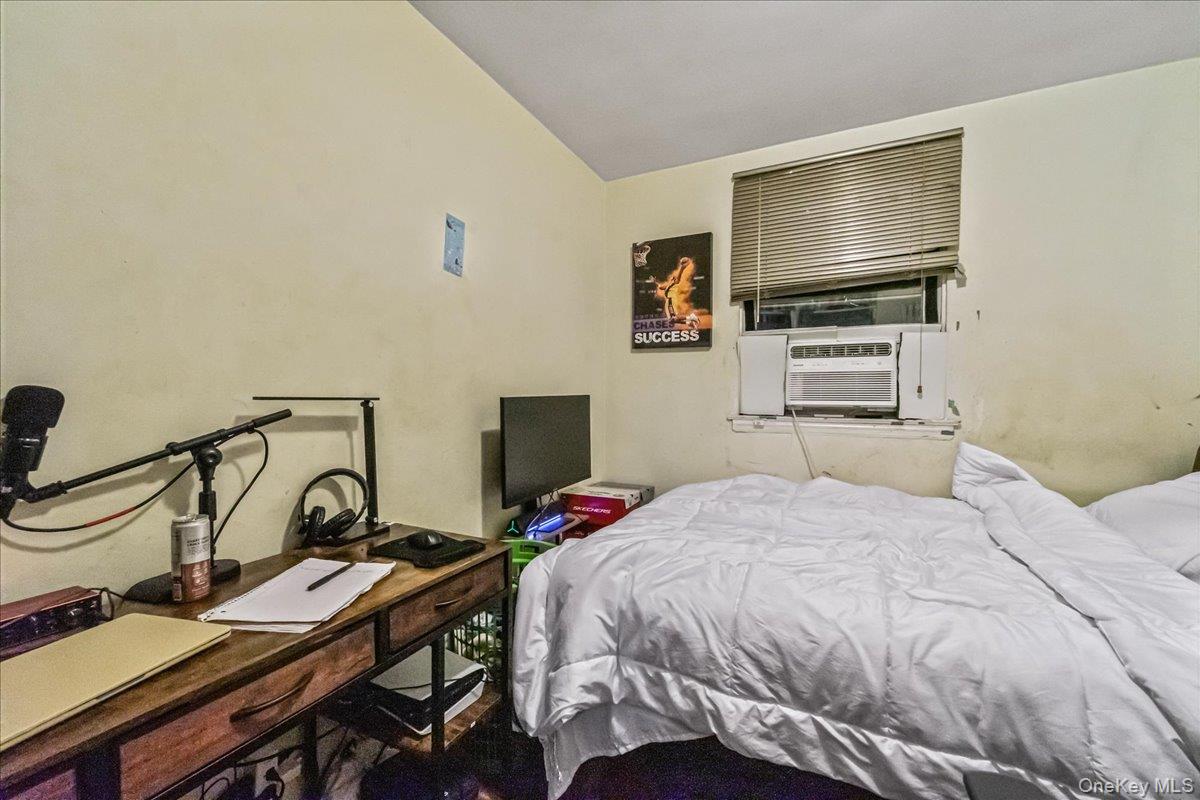 150-02 78th Road Queens, NY 11367 - Photo 22 of 23 a bedroom with a bed and a flat screen tv