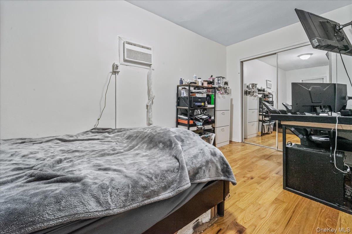 150-02 78th Road Queens, NY 11367 - Photo 10 of 23 a bedroom with a bed and a flat screen tv