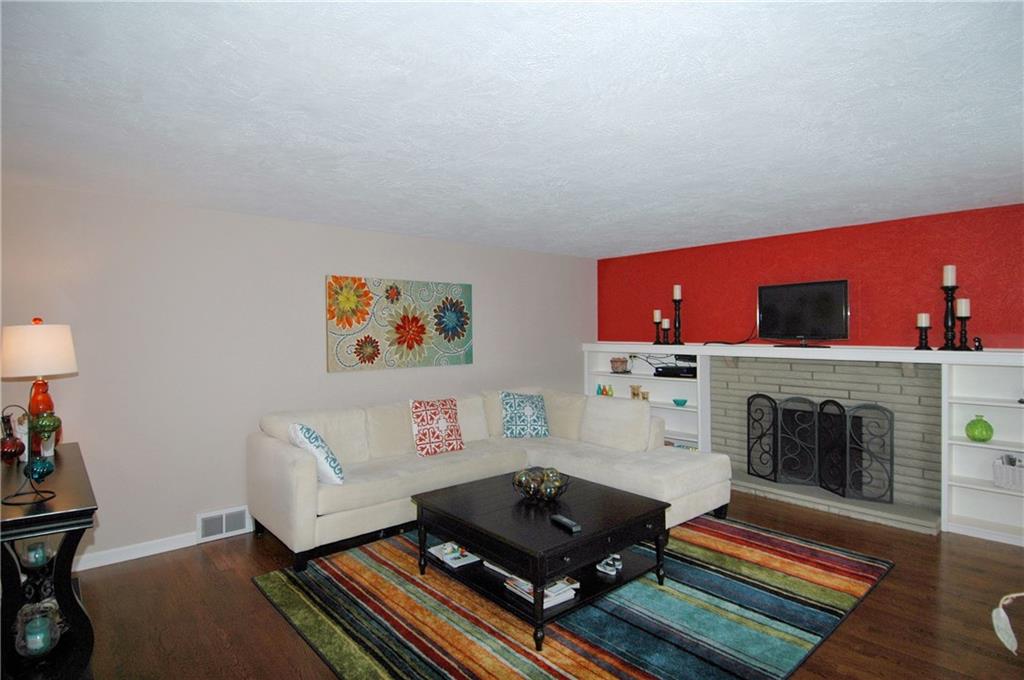 508 Sleepy Hollow Road Pittsburgh, PA 15228 - Photo 2 of 25 Living Room - New hardwood flooring, fireplace with brick surround and built-in shelving.