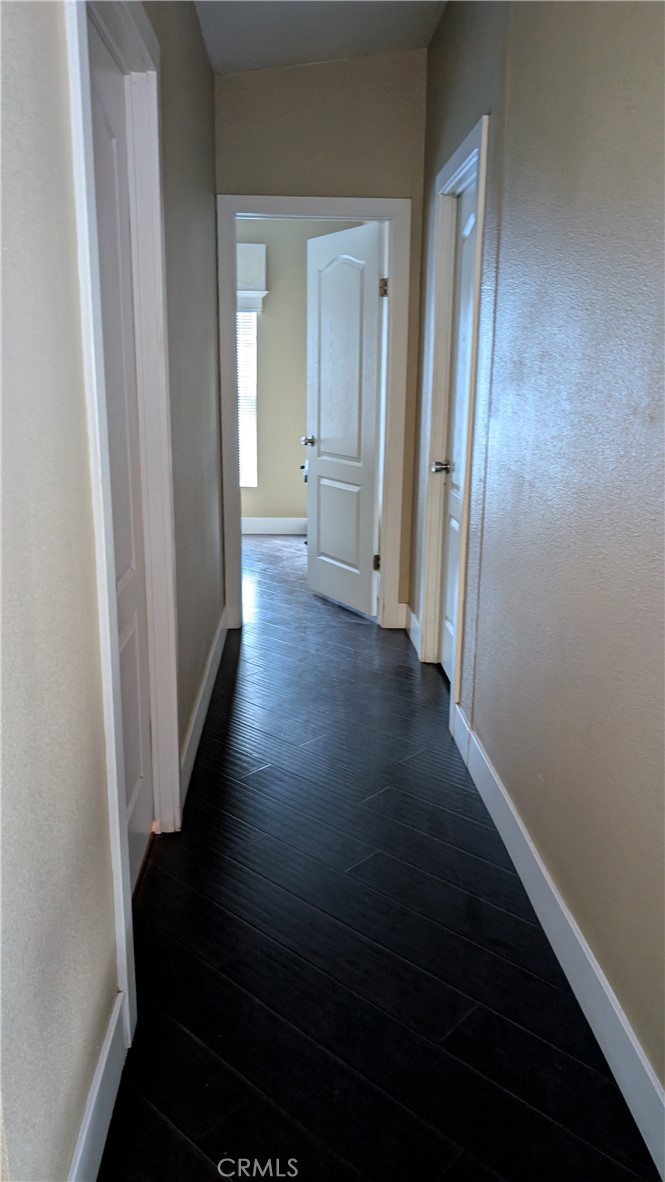3424 West Washington Avenue, Unit 228 Santa Ana, CA 92703 - Photo 11 of 31 a view of a hallway with wooden floor and a cabinet
