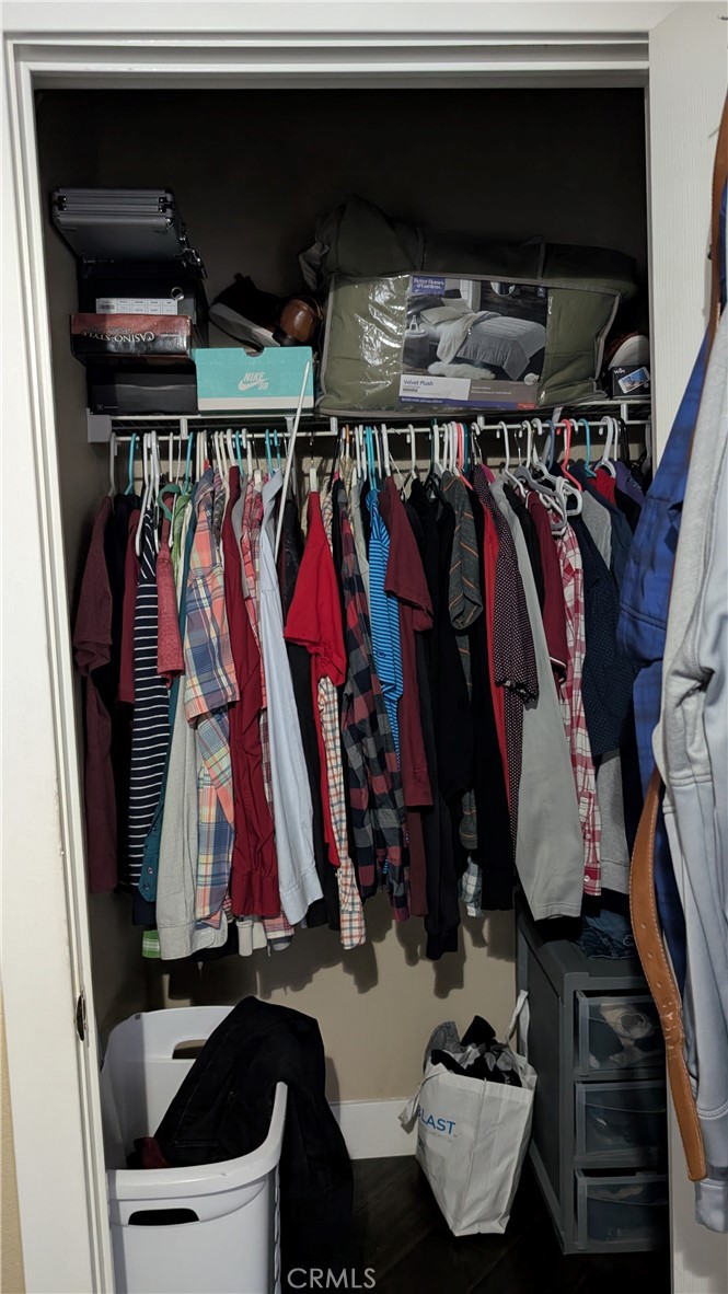 3424 West Washington Avenue, Unit 228 Santa Ana, CA 92703 - Photo 14 of 31 a view of walk in closet with clothes and shoes