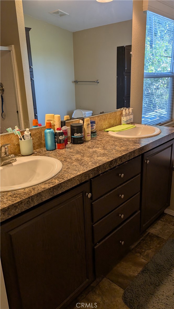 3424 West Washington Avenue, Unit 228 Santa Ana, CA 92703 - Photo 16 of 31 a bathroom with a granite countertop sink and a mirror