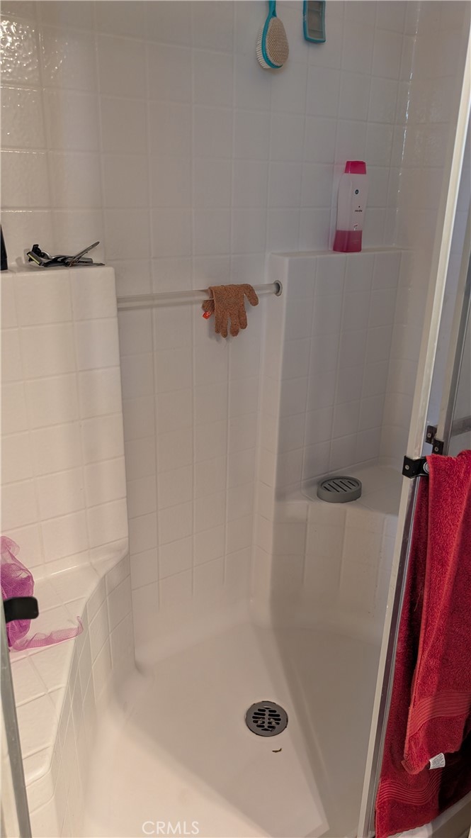 3424 West Washington Avenue, Unit 228 Santa Ana, CA 92703 - Photo 19 of 31 a bath tub sitting next to a shower