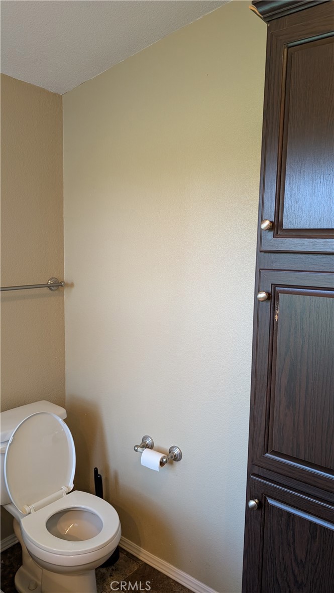 3424 West Washington Avenue, Unit 228 Santa Ana, CA 92703 - Photo 20 of 31 a white toilet sitting next to a shower